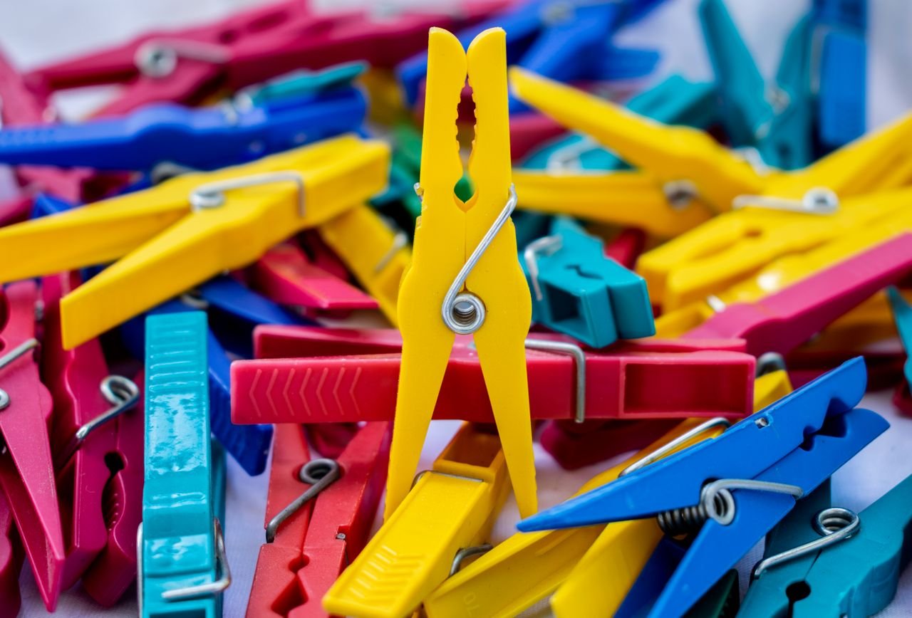 A close-up of colorful clothespins stacked together, showcasing vibrant hues and textures.