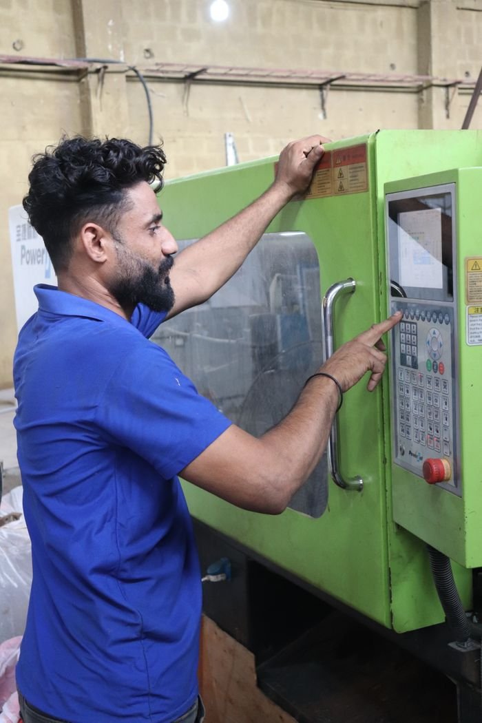 Crafting Captivating Headlines: Your awesome post title goes here Factory worker operating machinery, showcasing industrial work in Karachi, Pakistan.